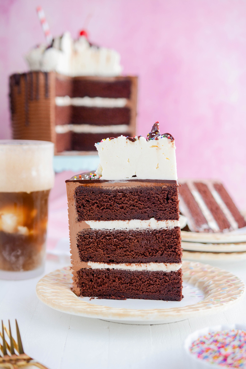 Close up shot of a slice of Chocolate Root Beer Float Cake on a plate.