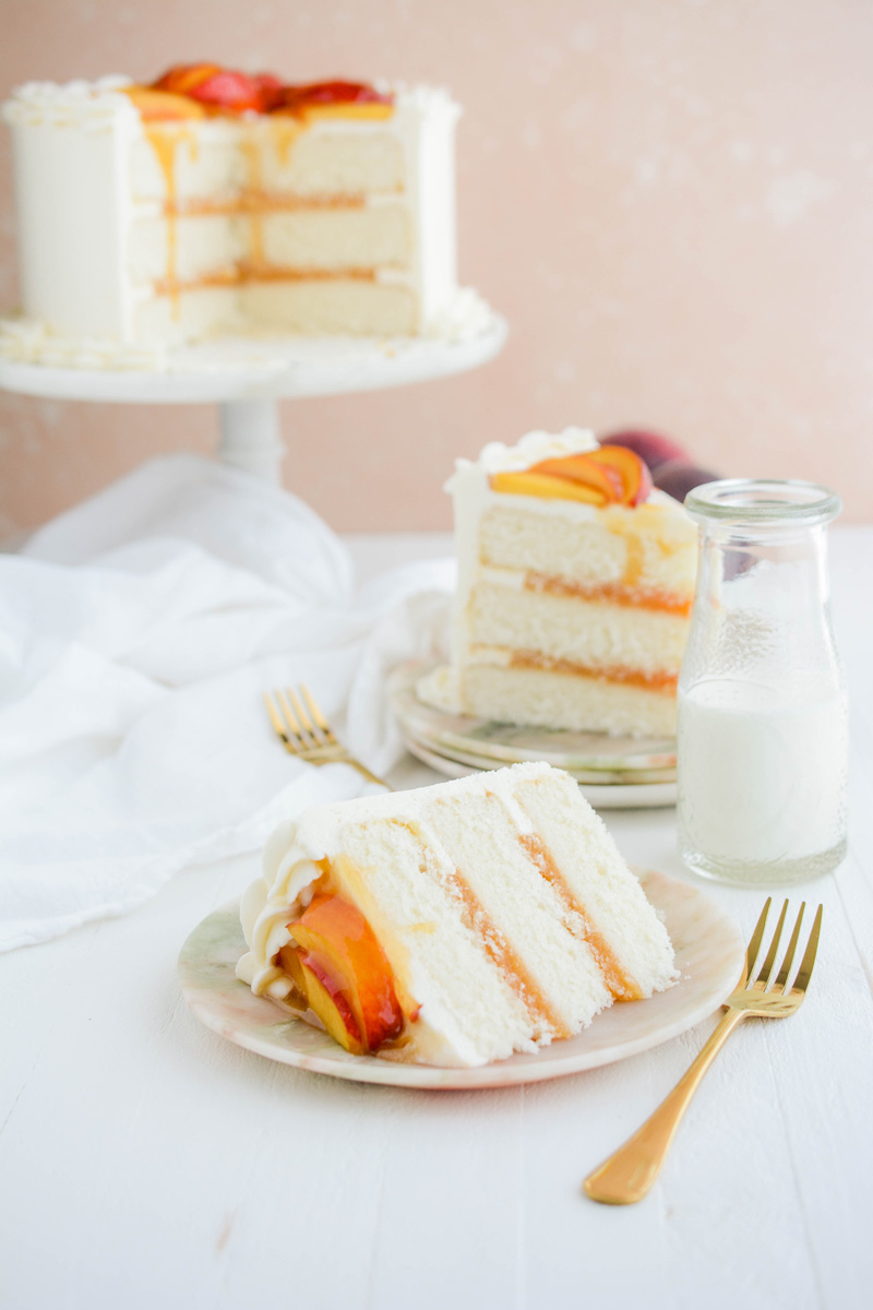 Wide open shot of sliced Peaches and Cream Layer Cake on plates.