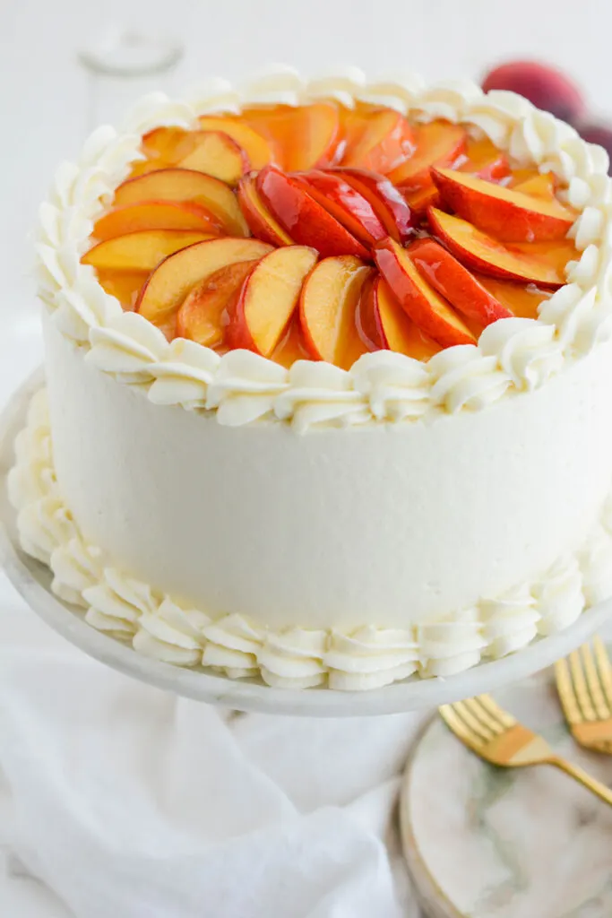 Three quarter angle close up of the peach decoration on top of Peaches and Cream Layer Cake.