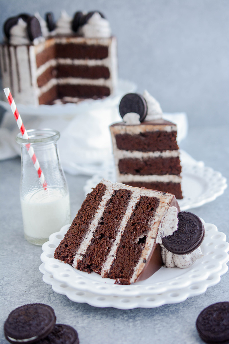 Ultimate Cookies and Cream Layer Cake slice laying on a white plate.