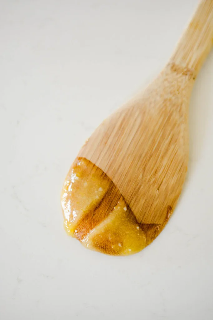 Close up of lime curd on wooden spoon for Key Lime Pie Cupcakes.