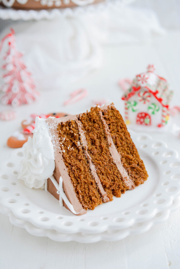 Three quarter angle of sliced Festive Gingerbread Layer Cake on plate.