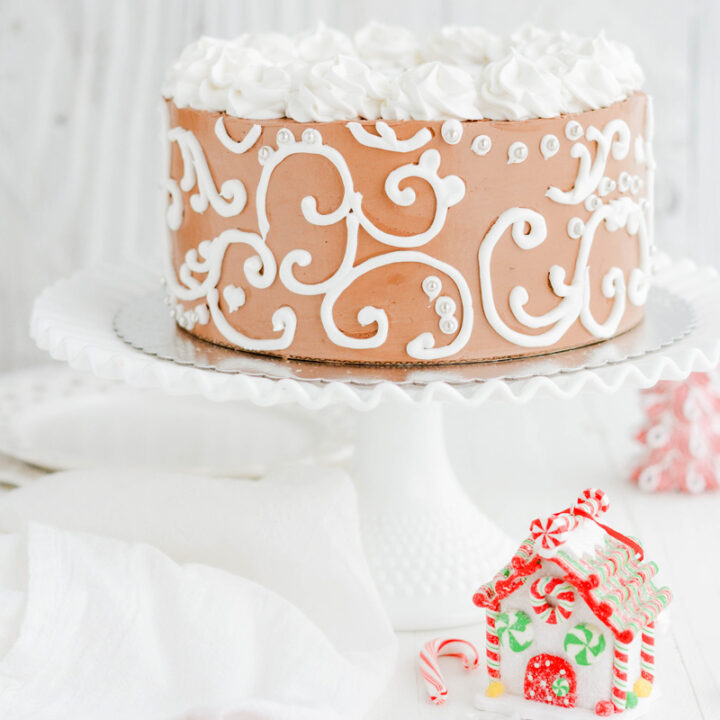 Festive Gingerbread Layer Cake on white cake pedestal.