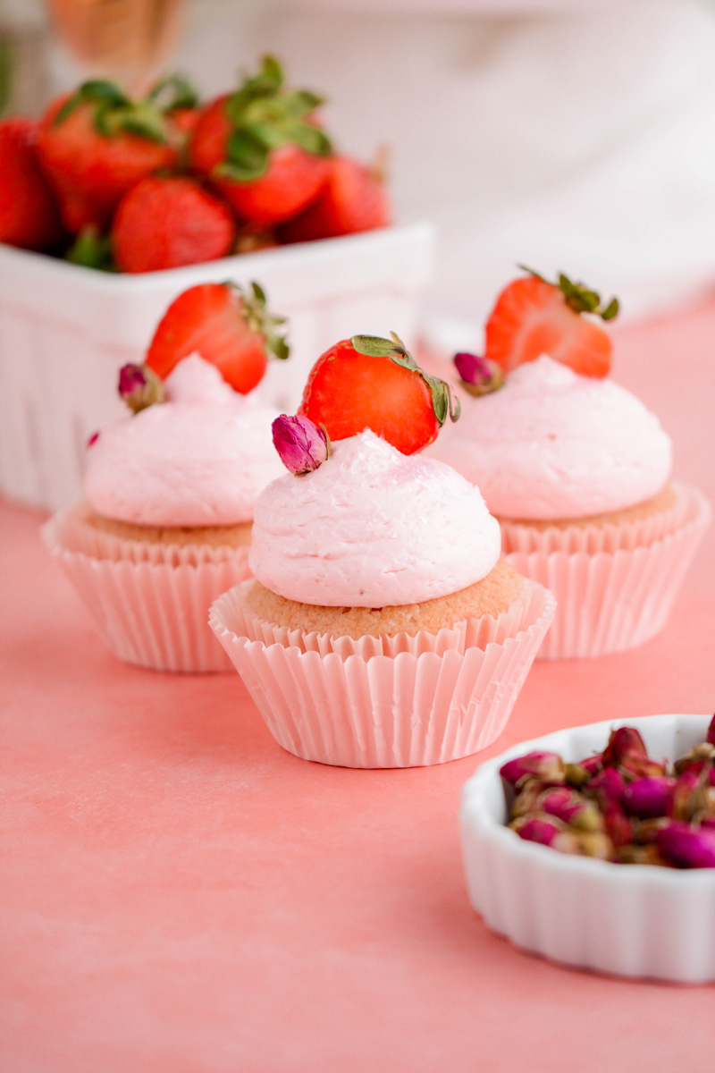 Close up of 3 Strawberry Rose Cupcakes.