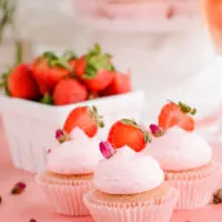 Strawberry Rose Cupcakes with rose buds and fresh strawberry slices.