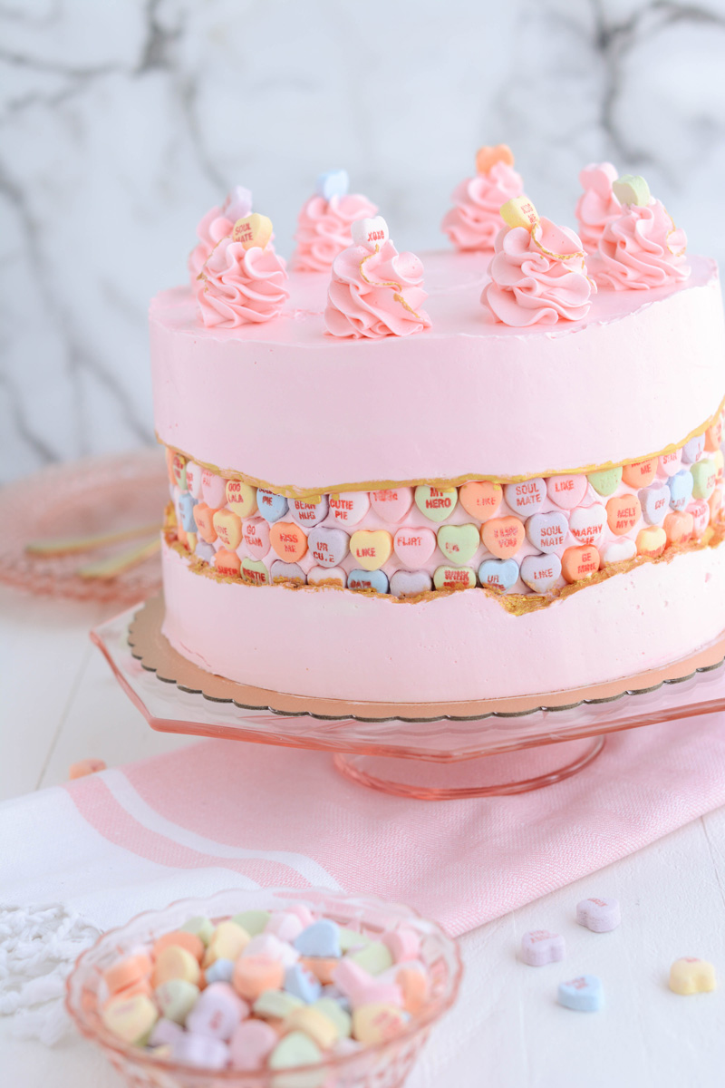 Off-center Valentine's Day Fault Line Cake on pink cake pedestal.