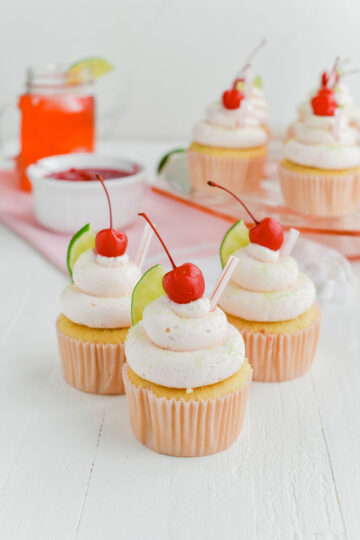 Three Cherry Limeade Cupcakes shot from a three quarter angle.
