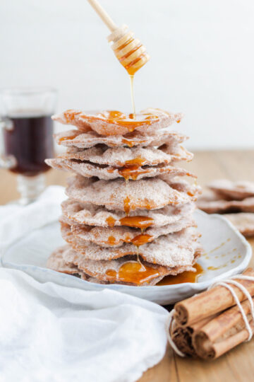 Bunuelos with honey drizzling on top.