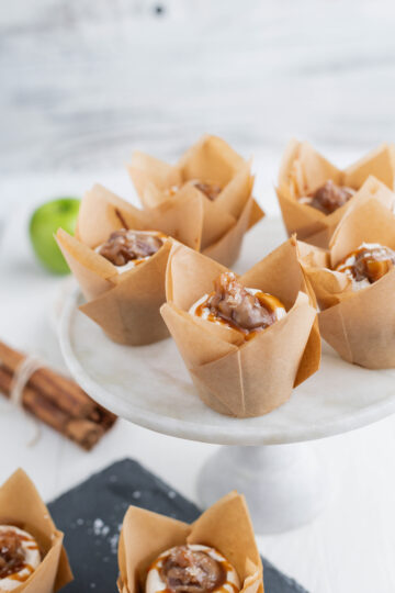 Salted Caramel Apple Cupcakes on marble cake pedestal.