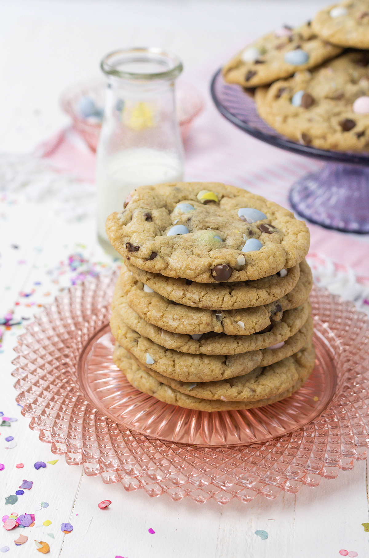 Close up of Easy Easter Egg Chocolate Chip Cookies stacked on a pink plate.
