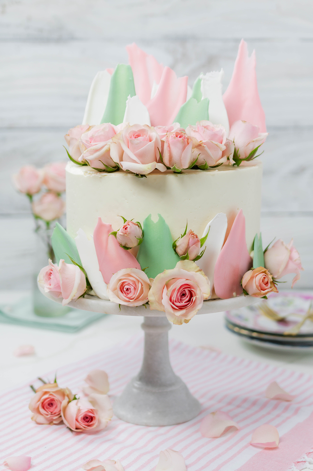 Blooms and Brushstrokes Vanilla Strawberry Cake wide open shot of cake on cake pedestal.