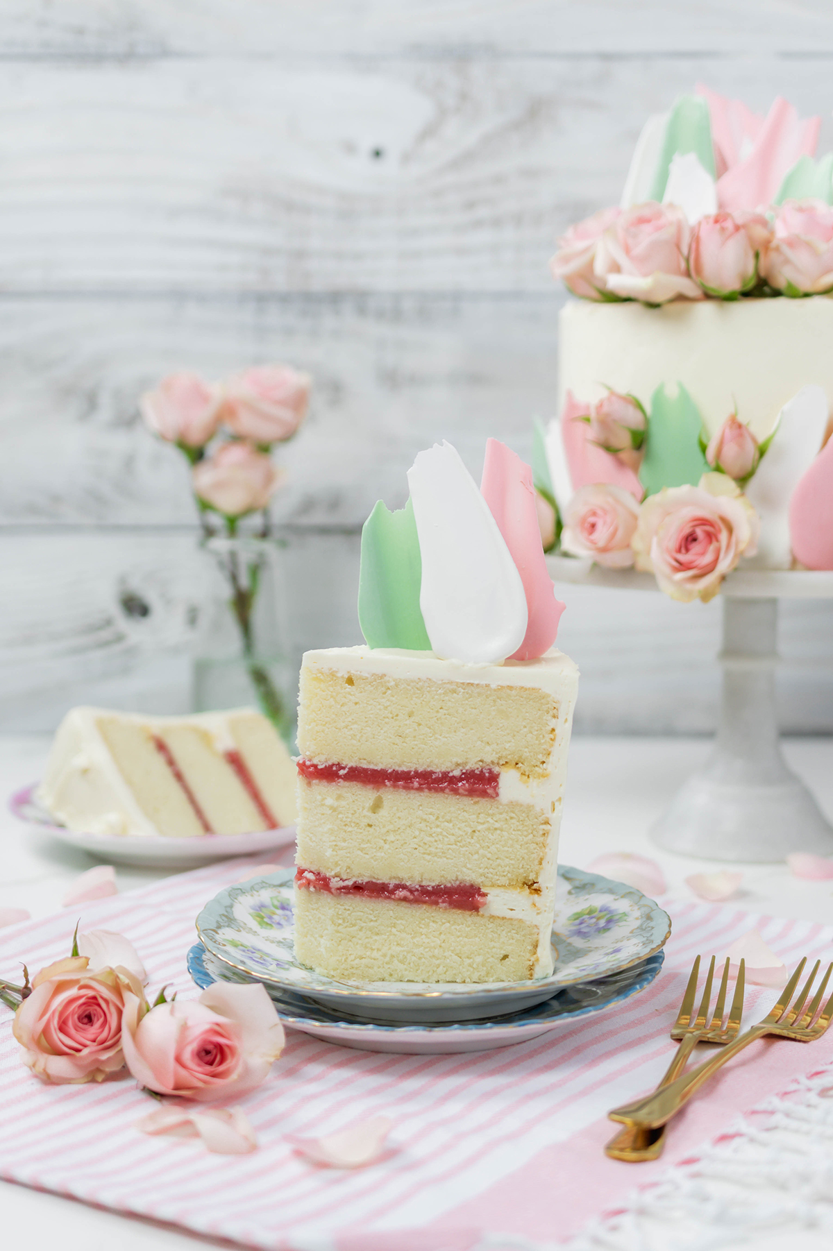 Wide open shot of sliced Blooms and Brushstrokes Vanilla Strawberry Cake.