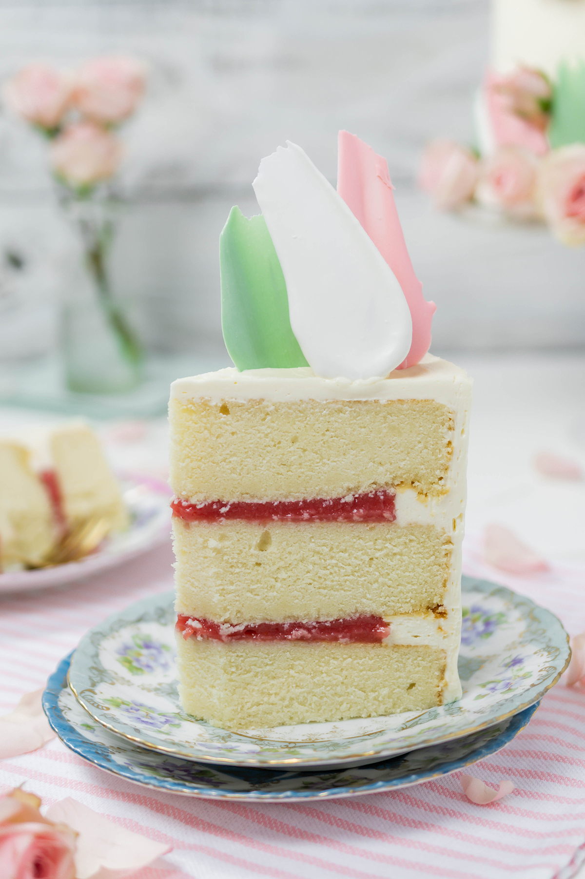 Close up of Blooms and Brushstrokes Vanilla and Strawberry Cake sliced.