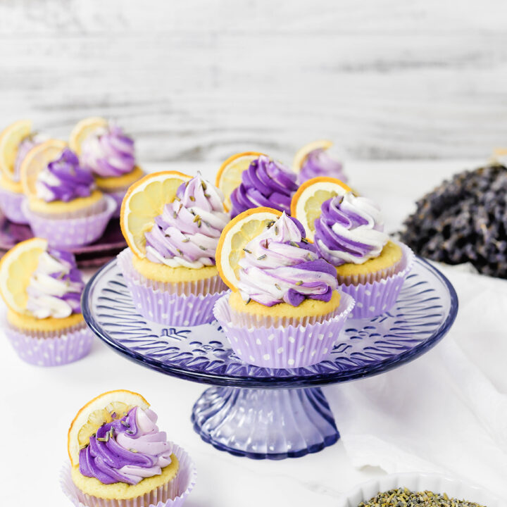Three quarter angle of Lavender Lemon Cupcakes on a lavender cake stand.