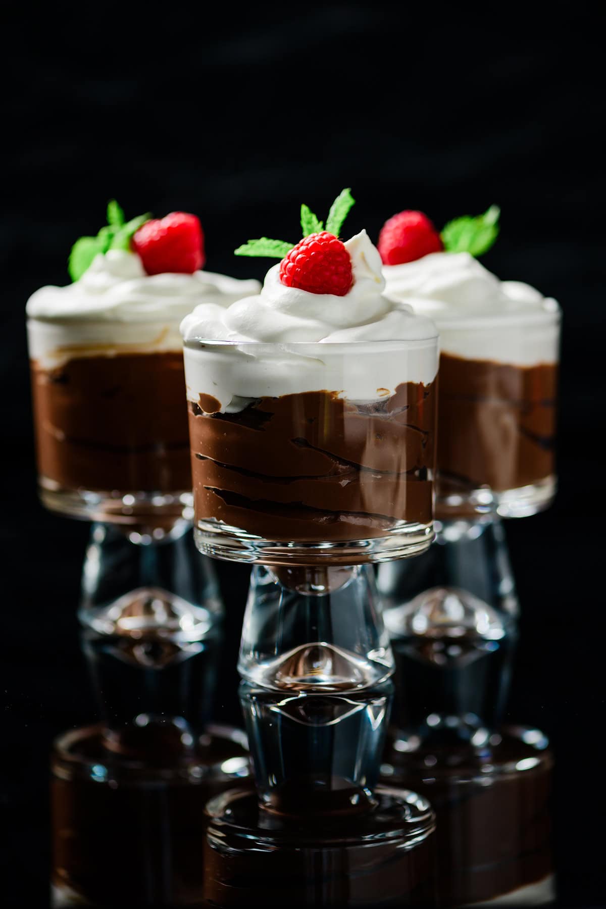 Three parfait glasses full of Protein Packed Chocolate Mocha Pudding.