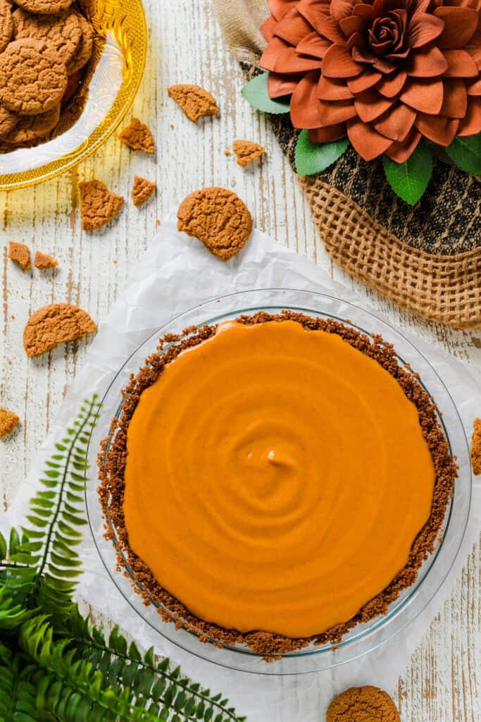 Overhead shot of pie crust with filling for Pumpkin Pie with Gingersnap Crust.