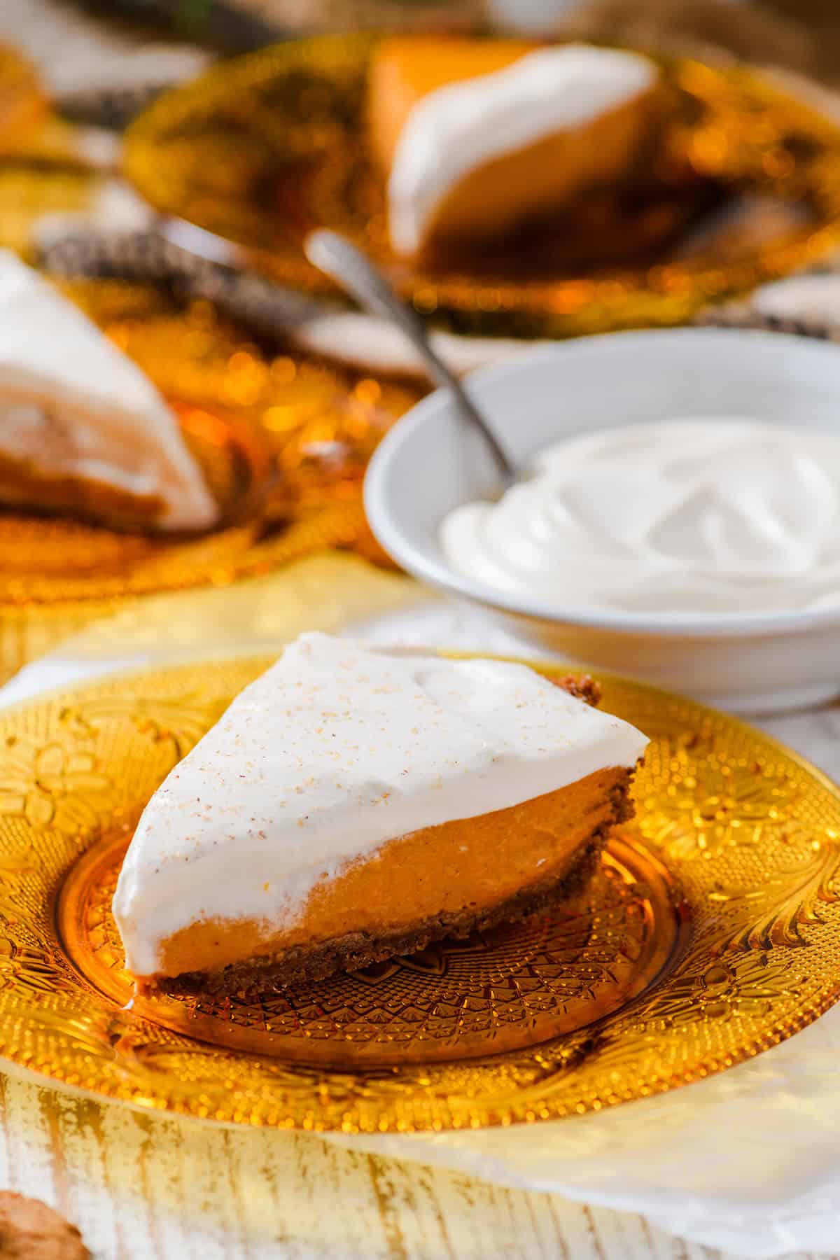 Three quarter angle close up of a slice of Pumpkin Pie with Gingersnap Crust.