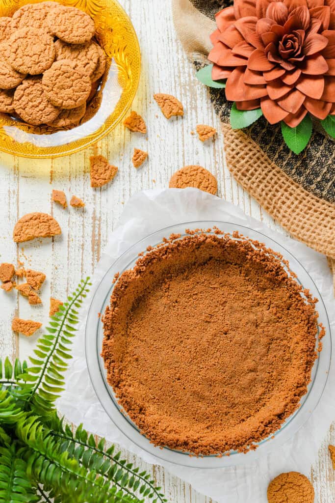 Overhead shot of baked pie crust for Pumpkin Pie with Gingersnap Crust.