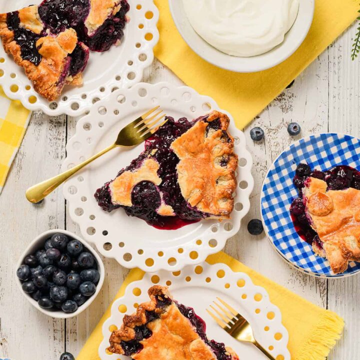 Overhead spread of sliced blueberry pie.