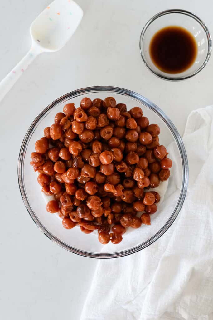 Overhead shot of cherry pie filling ingredients in a glass bowl for Easy Cherry Pie.