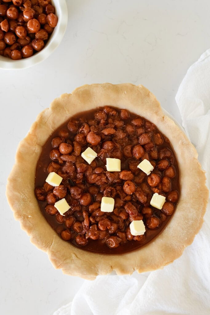 Overhead shot of cherry pie filling in pie dough for Easy Cherry Pie.