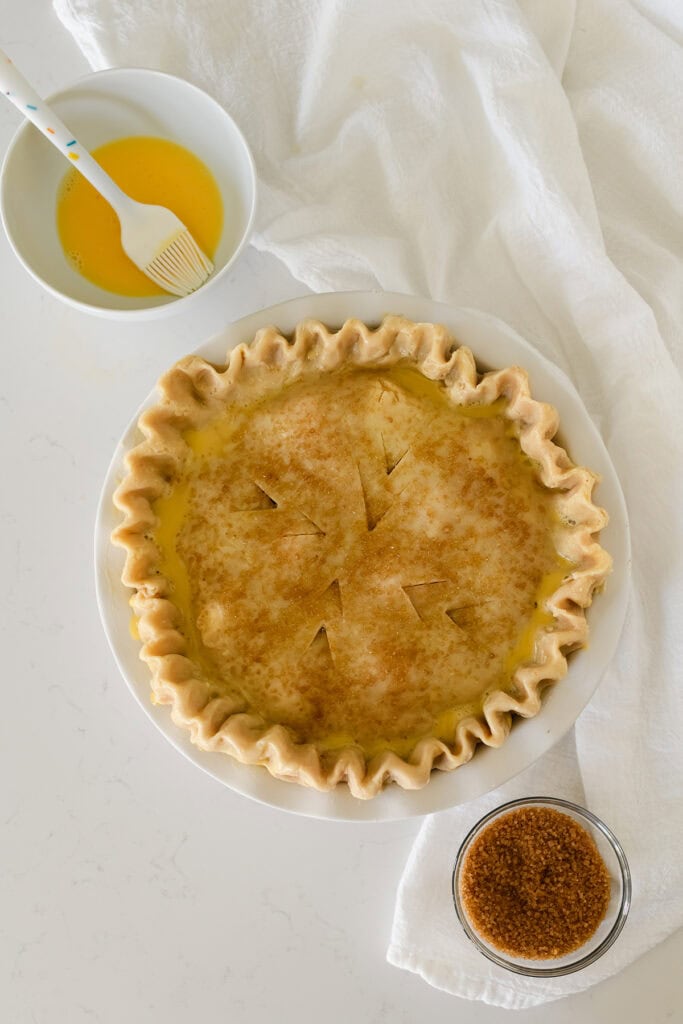 Overhead shot of Easy Cherry Pie topped with pie dough, egg wash and sugar.