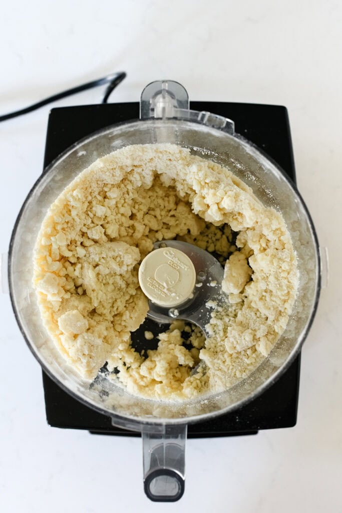 Overhead shot in food processor of Step 1 of Pie Dough process for Easy Cherry Pie.