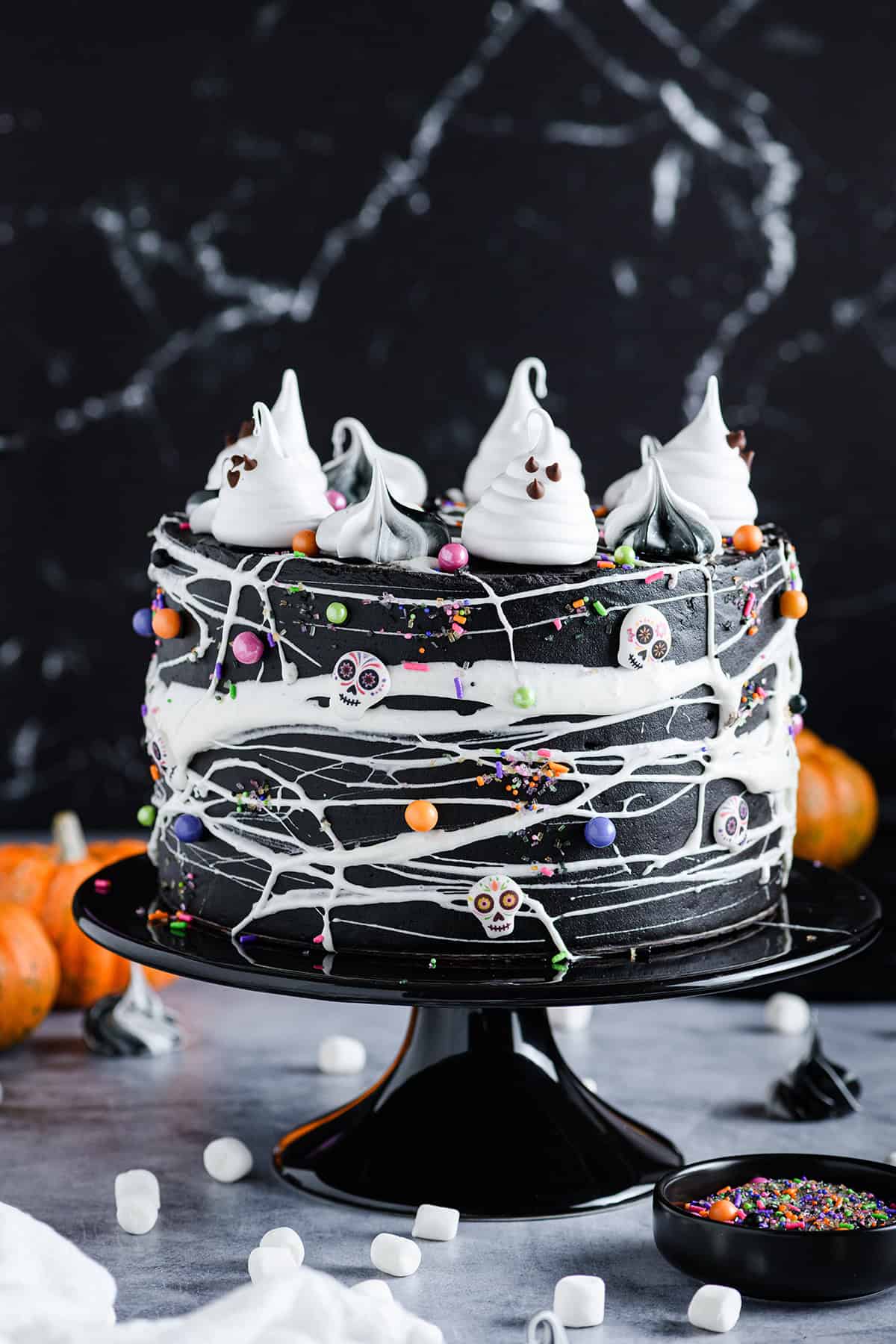 Close up straight on angle of Black Velvet Halloween Cake on black cake pedestal.