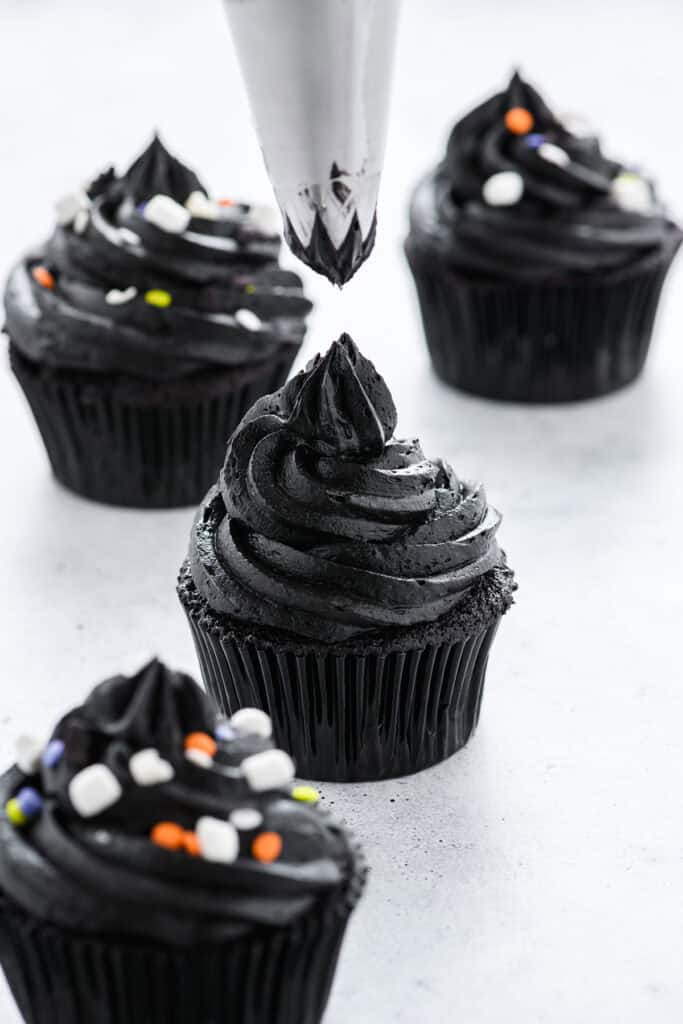 Three quarter angle of Black Velvet Halloween Cupcakes frosted.