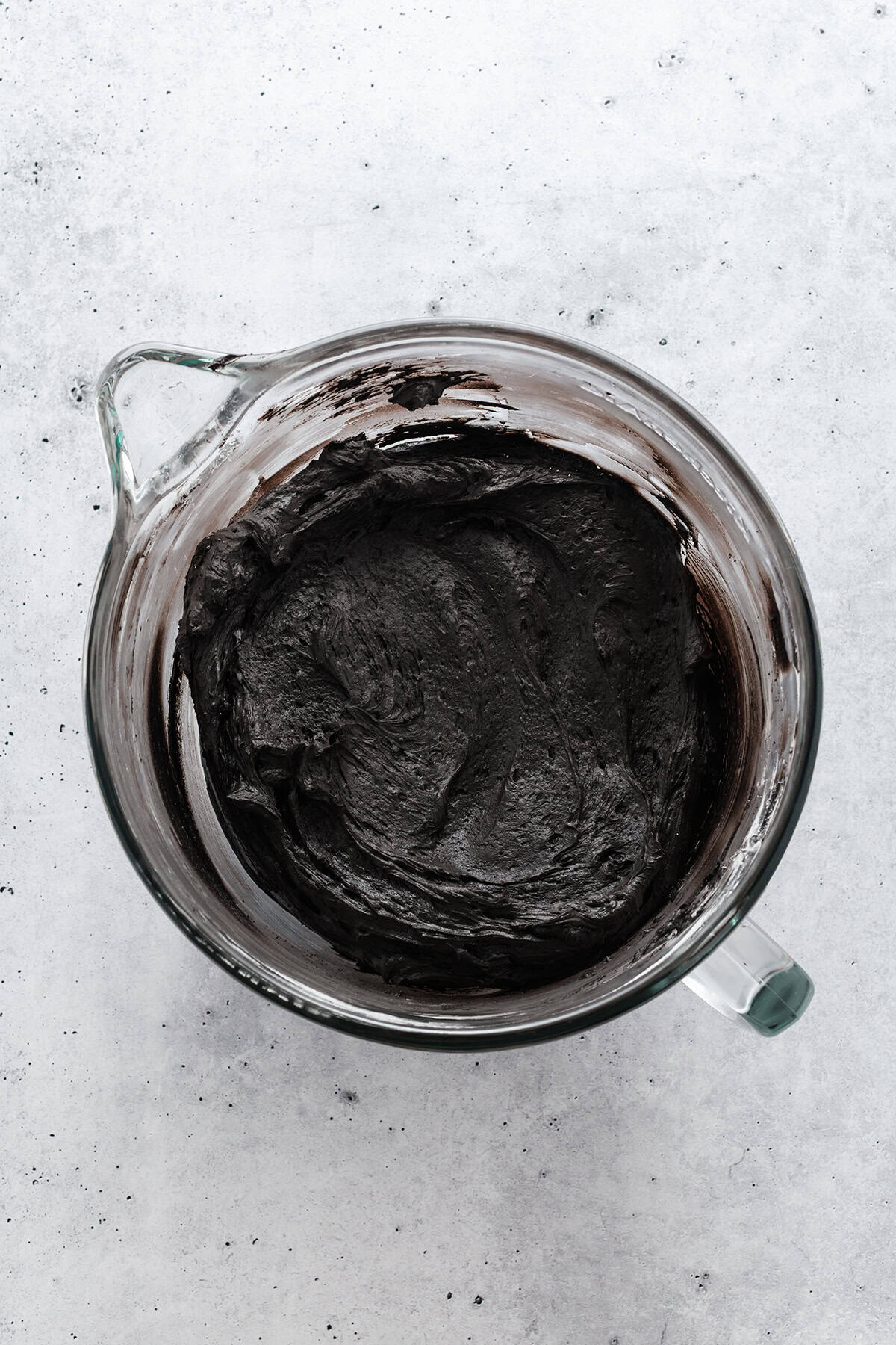 Overhead shot of completed black buttercream for Black Velvet Halloween Cupcakes