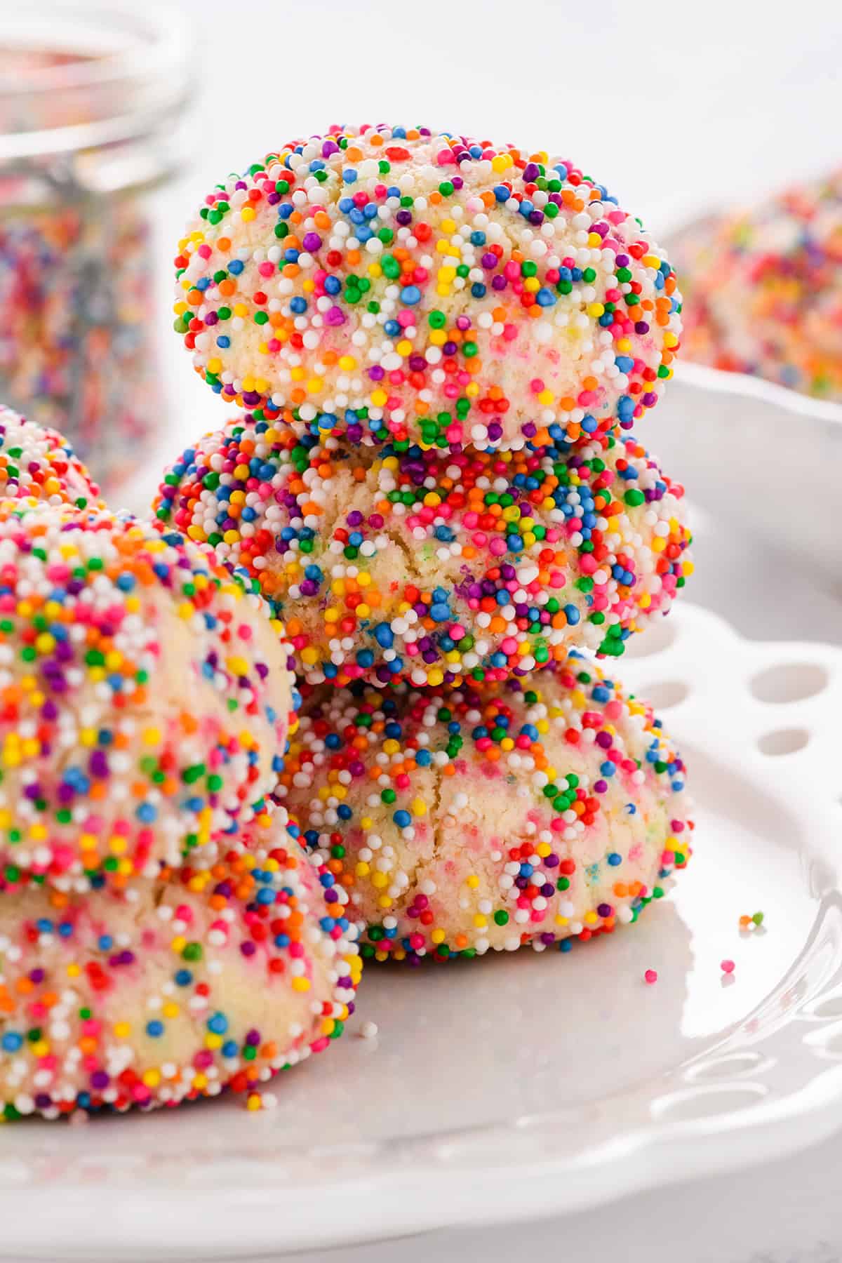 Close up shot of stacked Mexican Sprinkle Cookies on a plate.