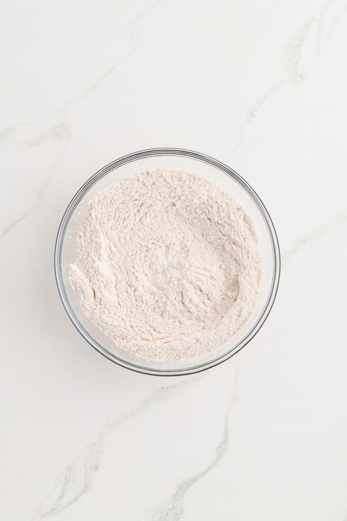 Overhead shot of dry ingredients for Pumpkin Spice Layer Cake with Caramel Cream Cheese Frosting. 