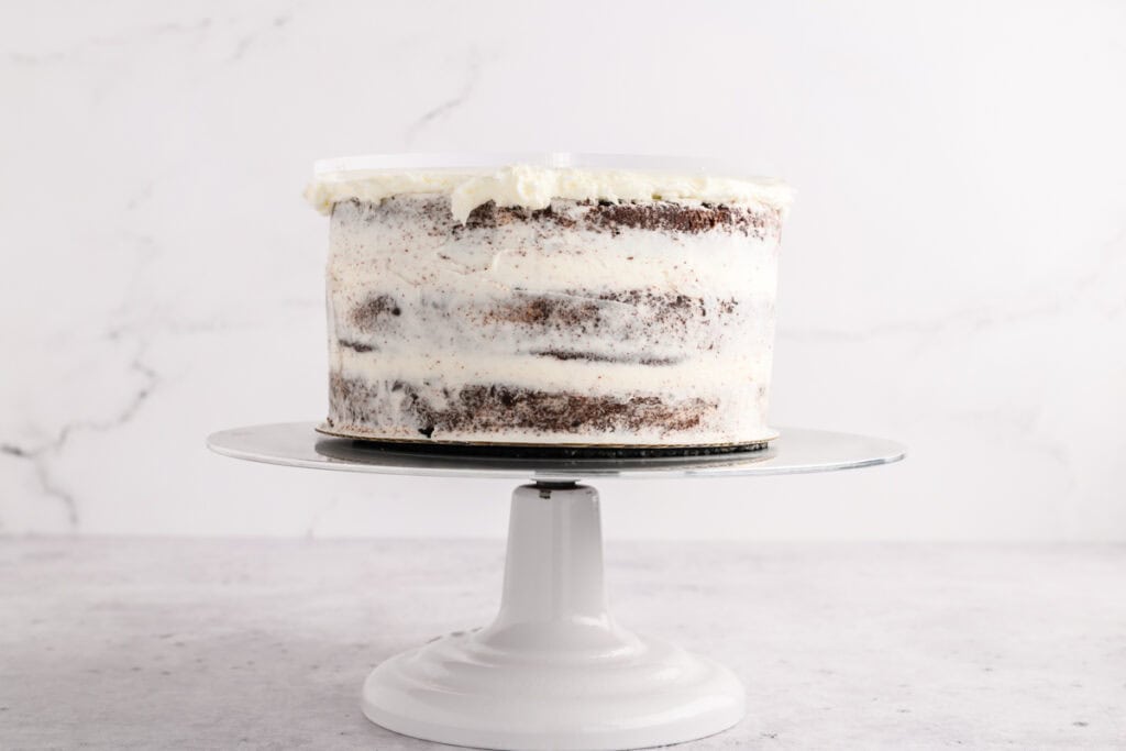 Crumb coated Chocolate Peppermint Layer Cake with acrylic disc.