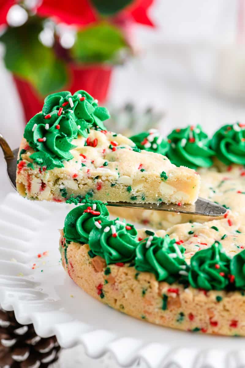 Close up shot sliced Christmas Confetti Cookie Cake on cake server.