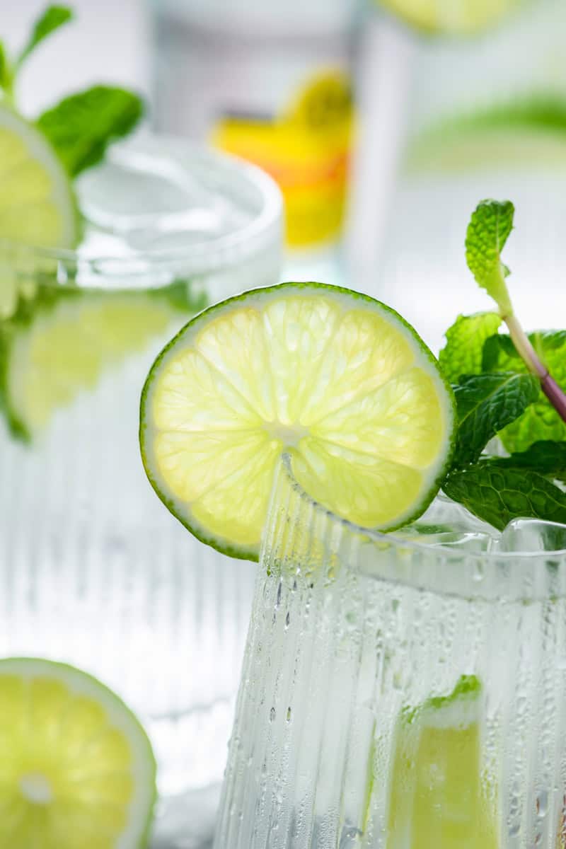 Close up of lime garnish on a glass of Hangover Cure.