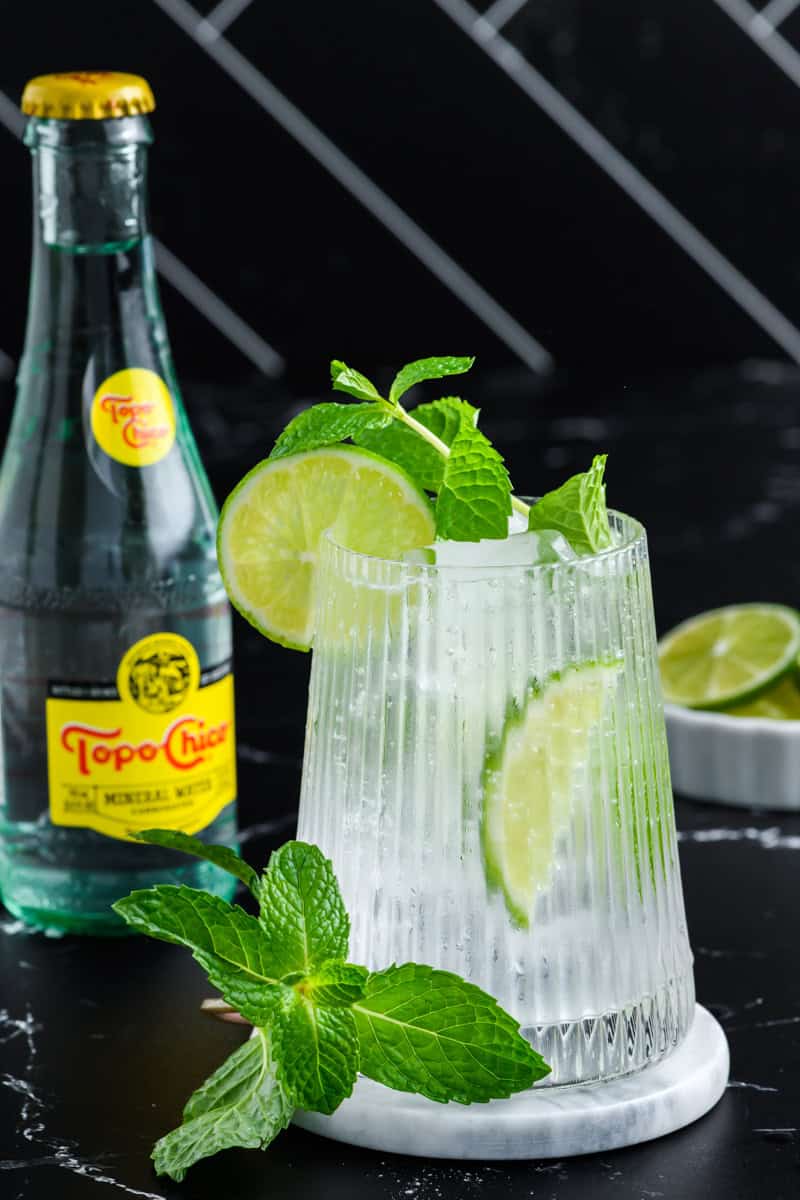 One glass of Hangover Cure with a bottle of Topo Chico head on shot.