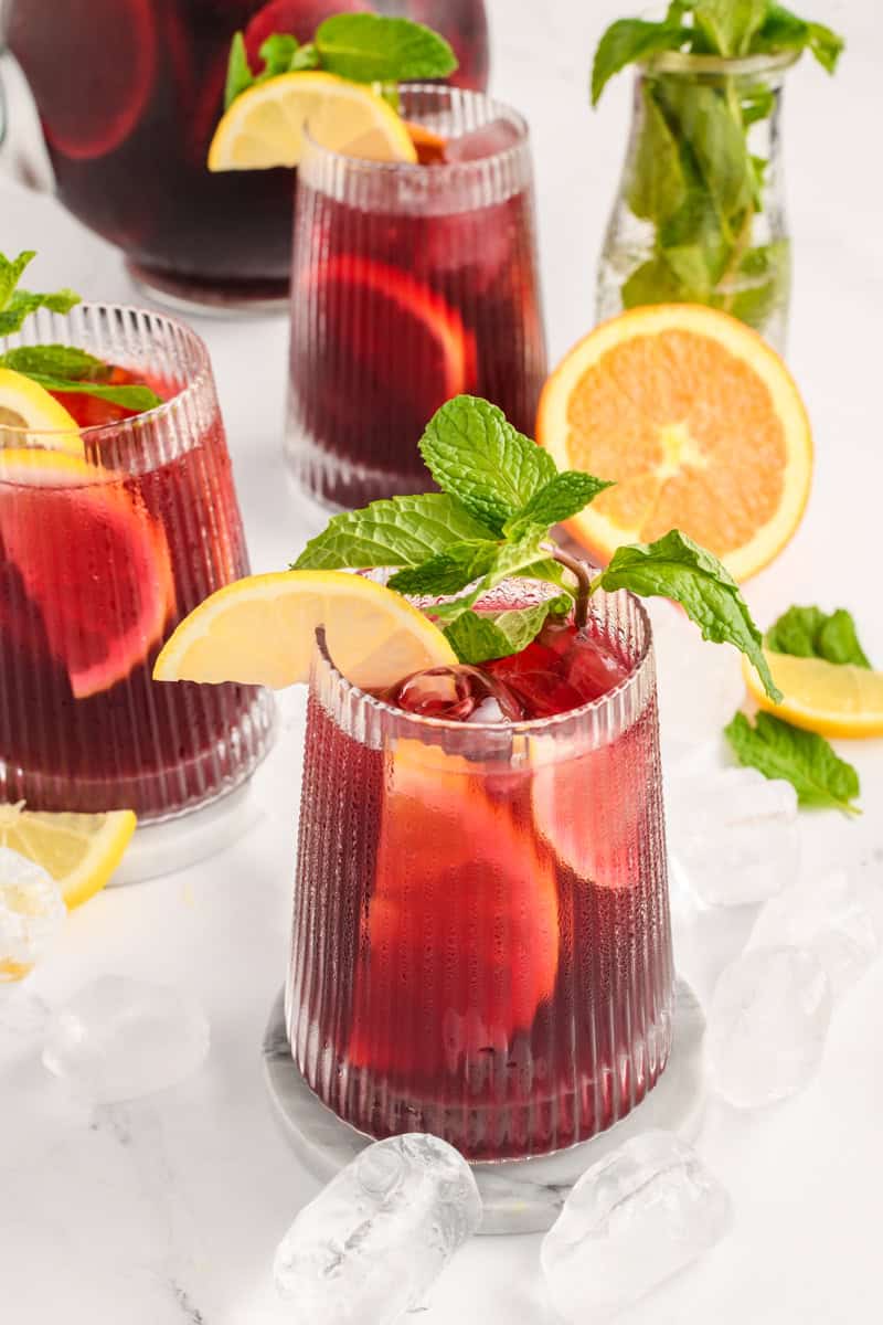 Angled wide open shot of Simple Sangria in 3 glasses.