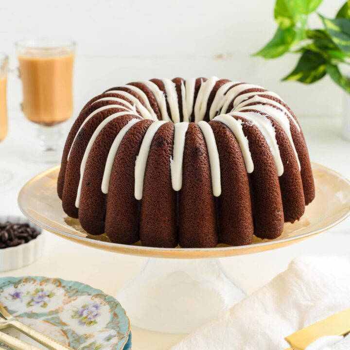 Healthier Chocolate Coffee Cake on golden cake stand.