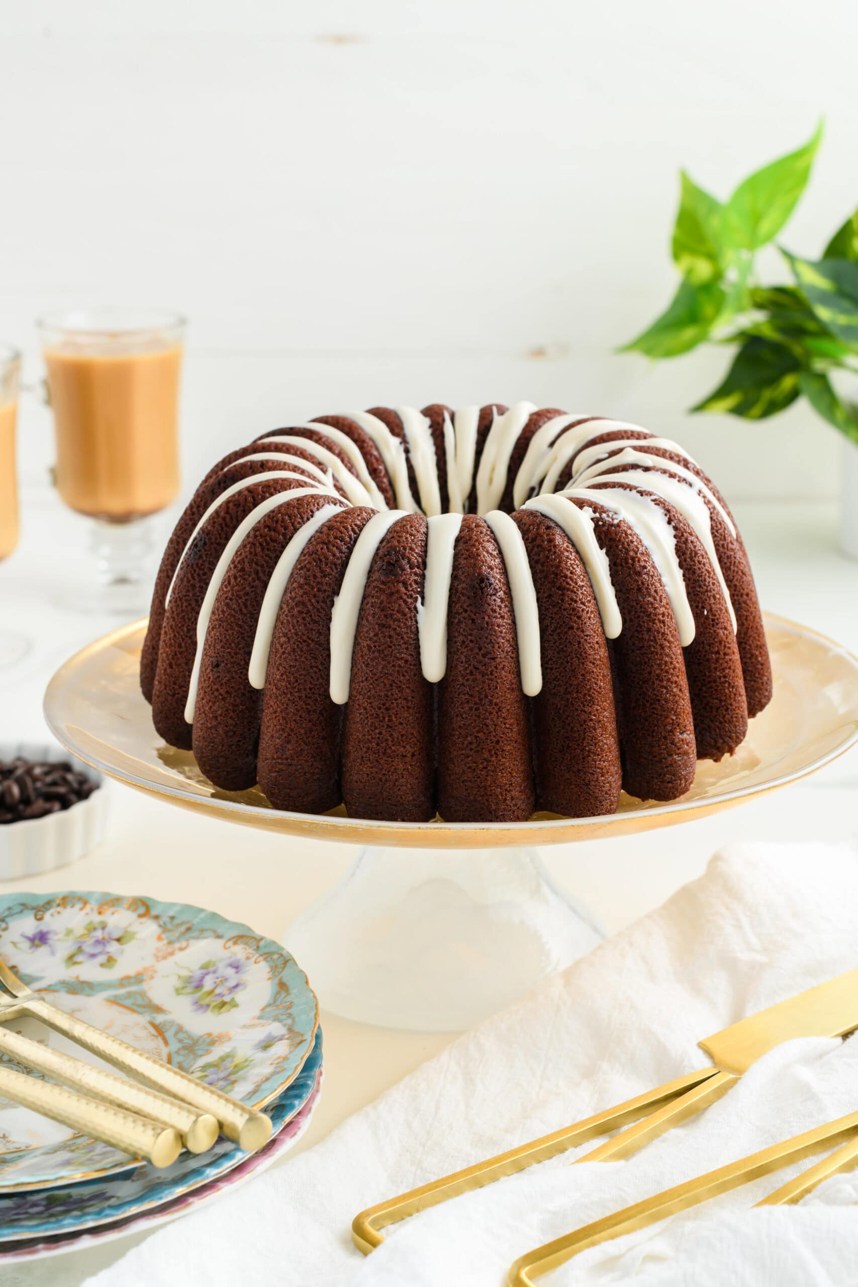 Healthier Chocolate Coffee Cake on golden cake stand.