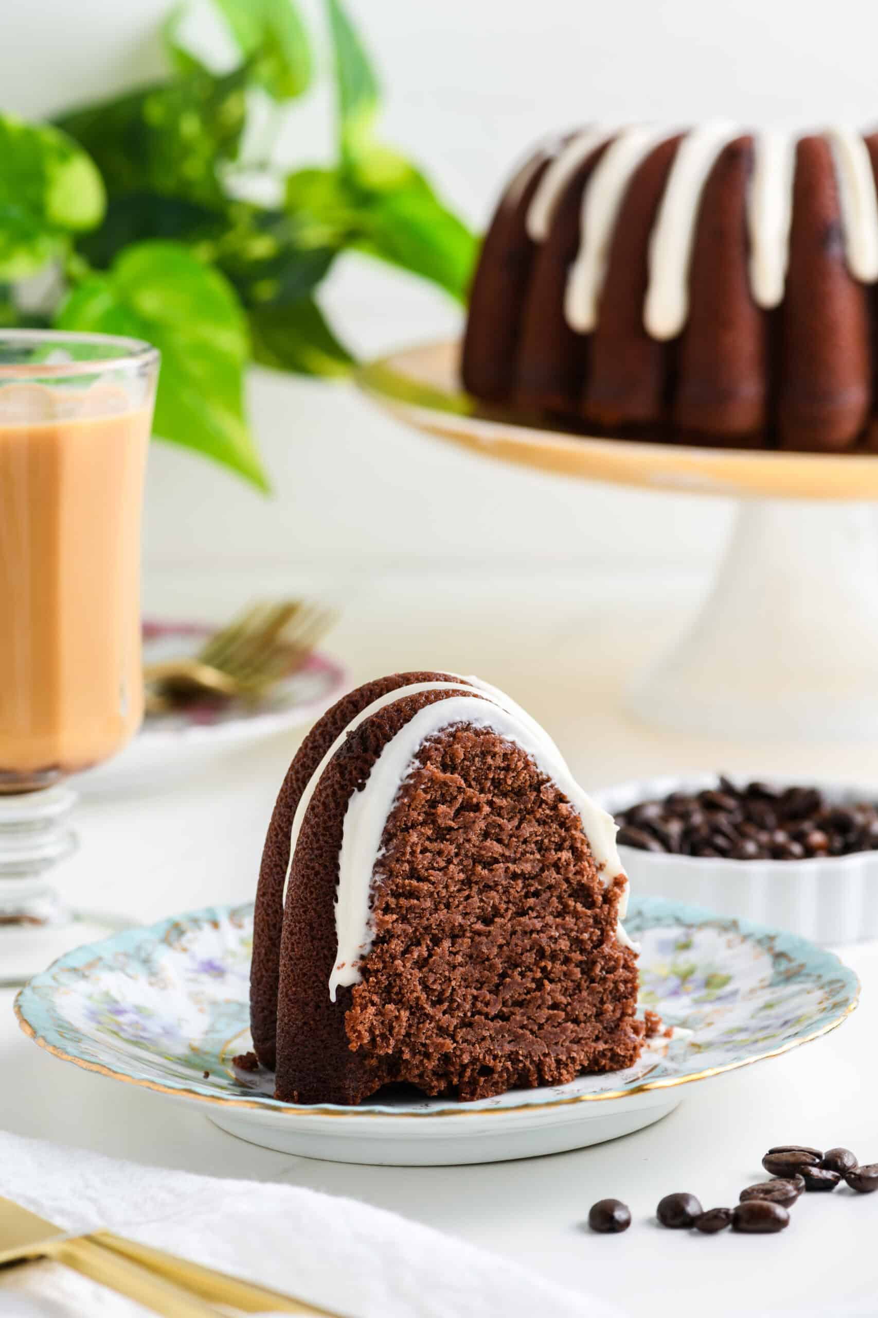 One sliced Healthier Chocolate Coffee Cake on a cake plate.