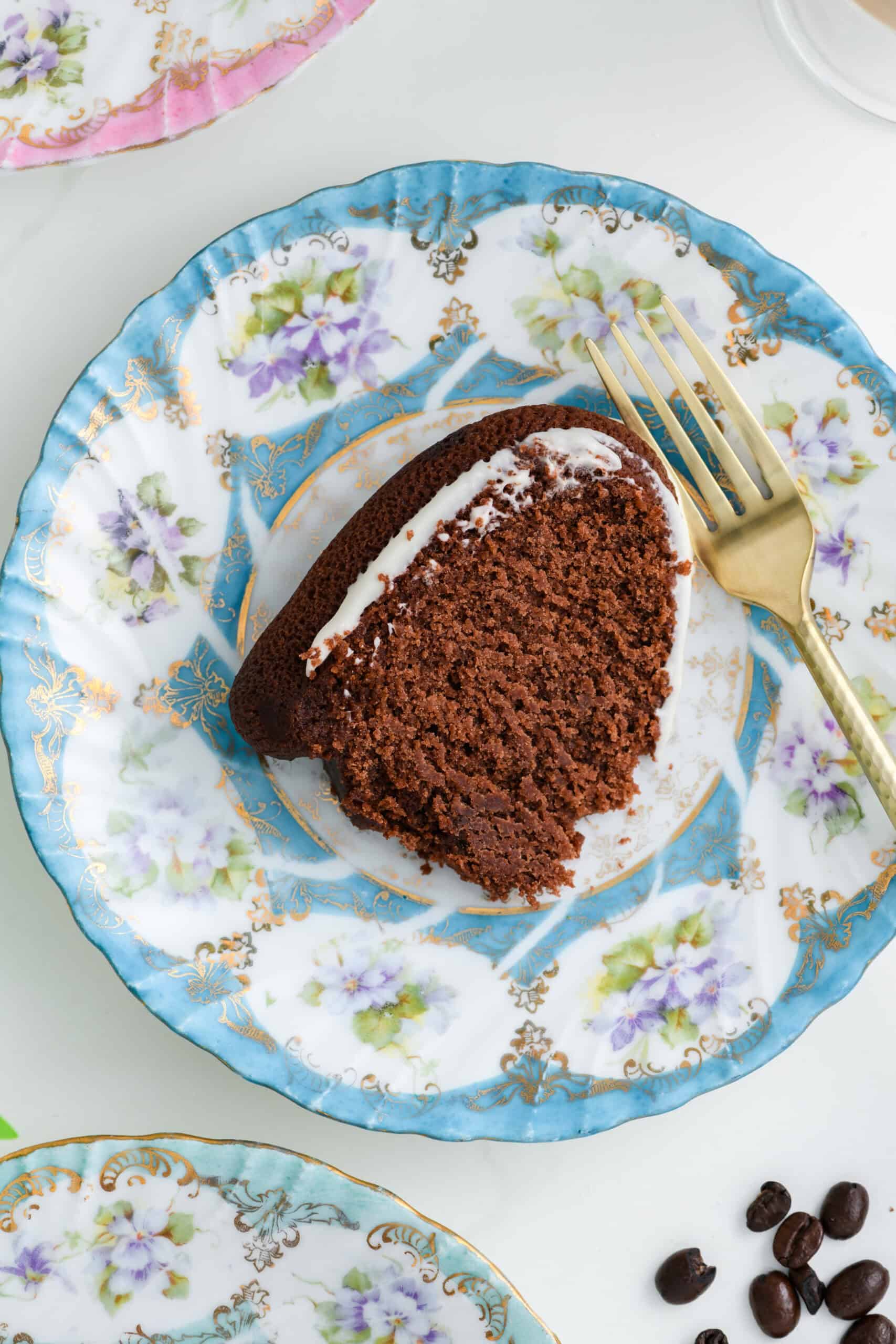 Overhead close up of sliced Healthier Chocolate Coffee Cake on laying down on cake plate with fork.