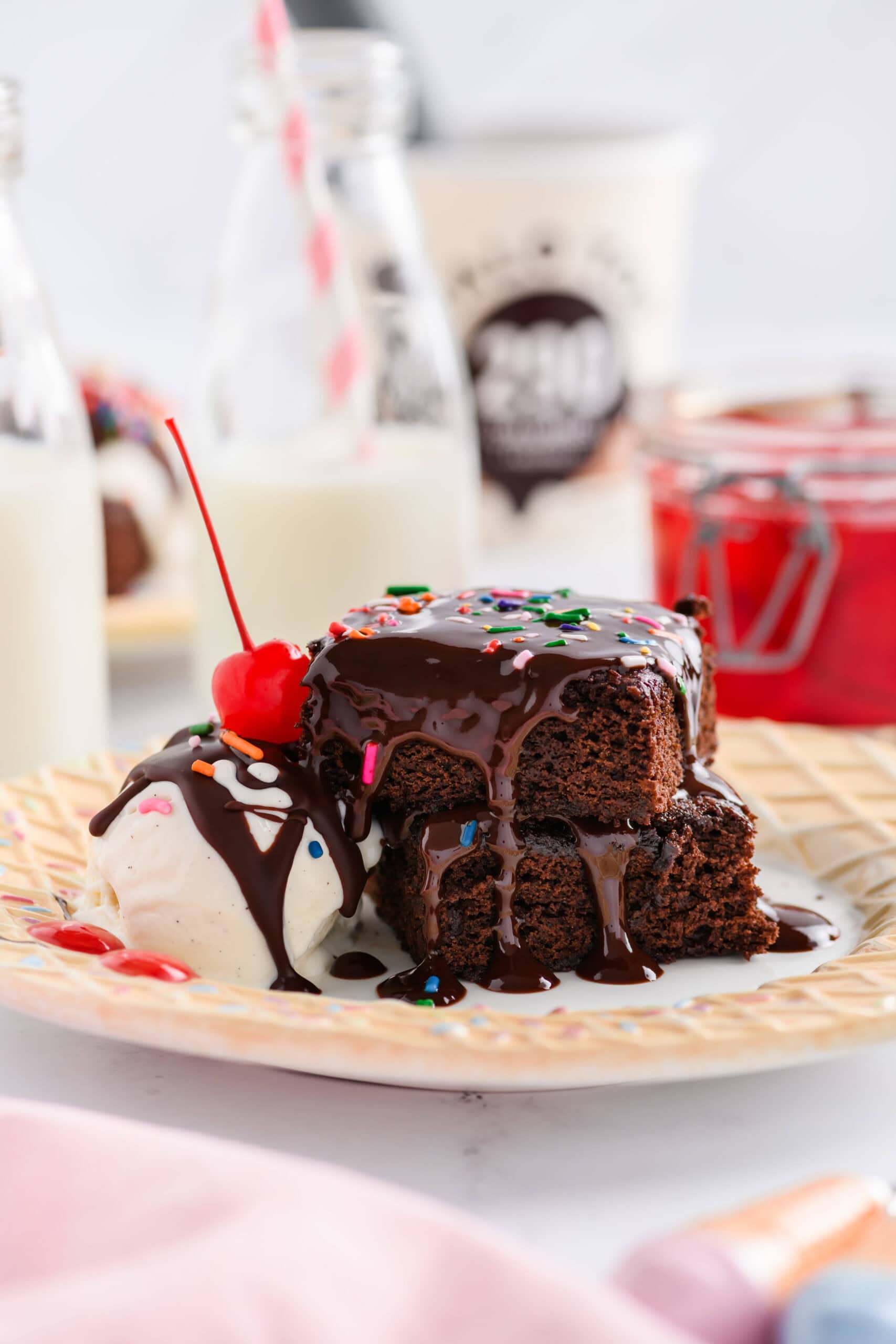 Two stacked brownies with ice cream on a plate for Lightened Up Brownie a la Mode.
