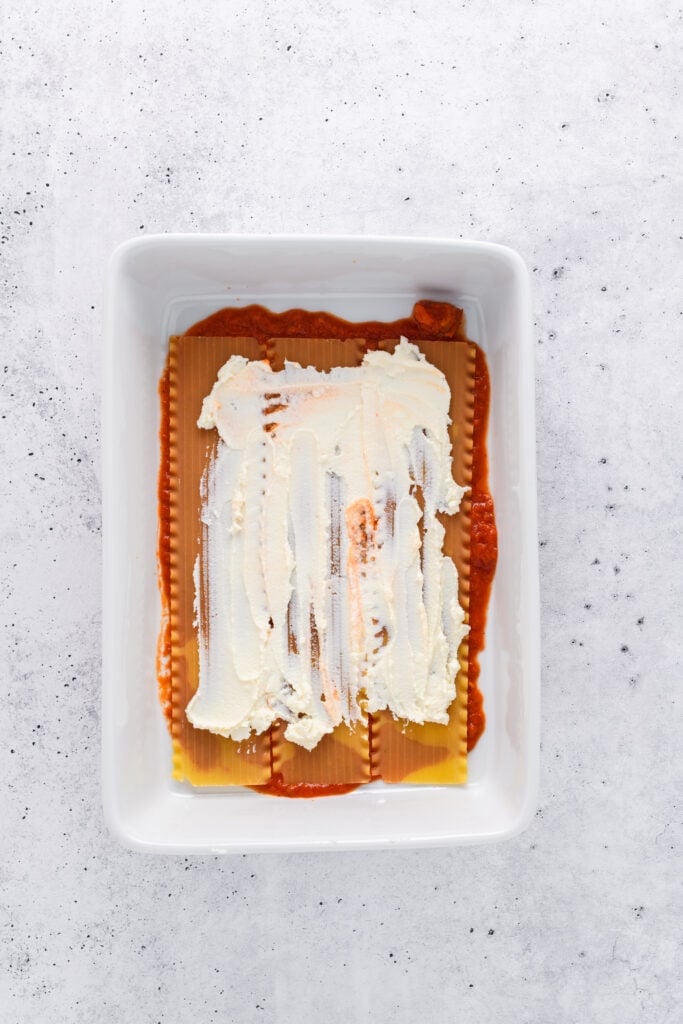 Overhead shot of lasagna layering for Easy Sausage and Mushroom Lasagna step 2.