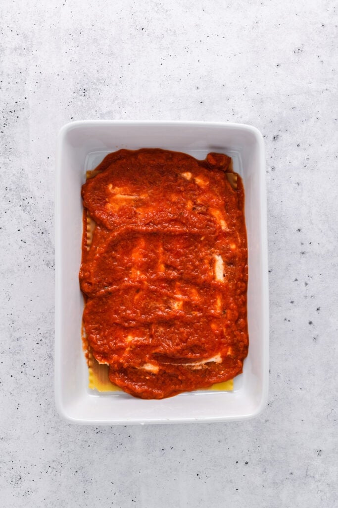 Overhead shot of lasagna layering for Easy Sausage and Mushroom Lasagna step 3.