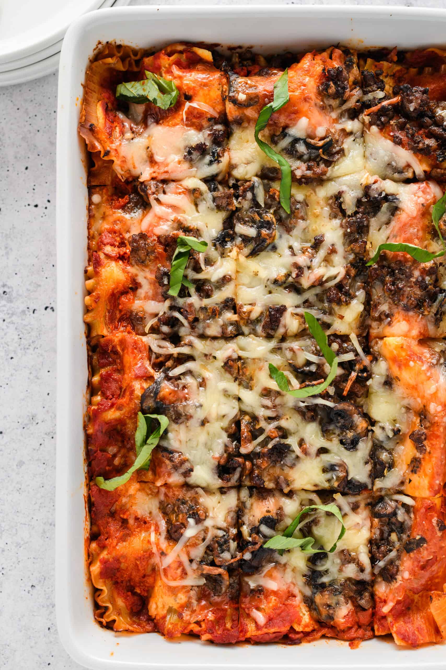 Close up overhead shot of sliced Easy Sausage and Mushroom Lasagna on casserole dish.