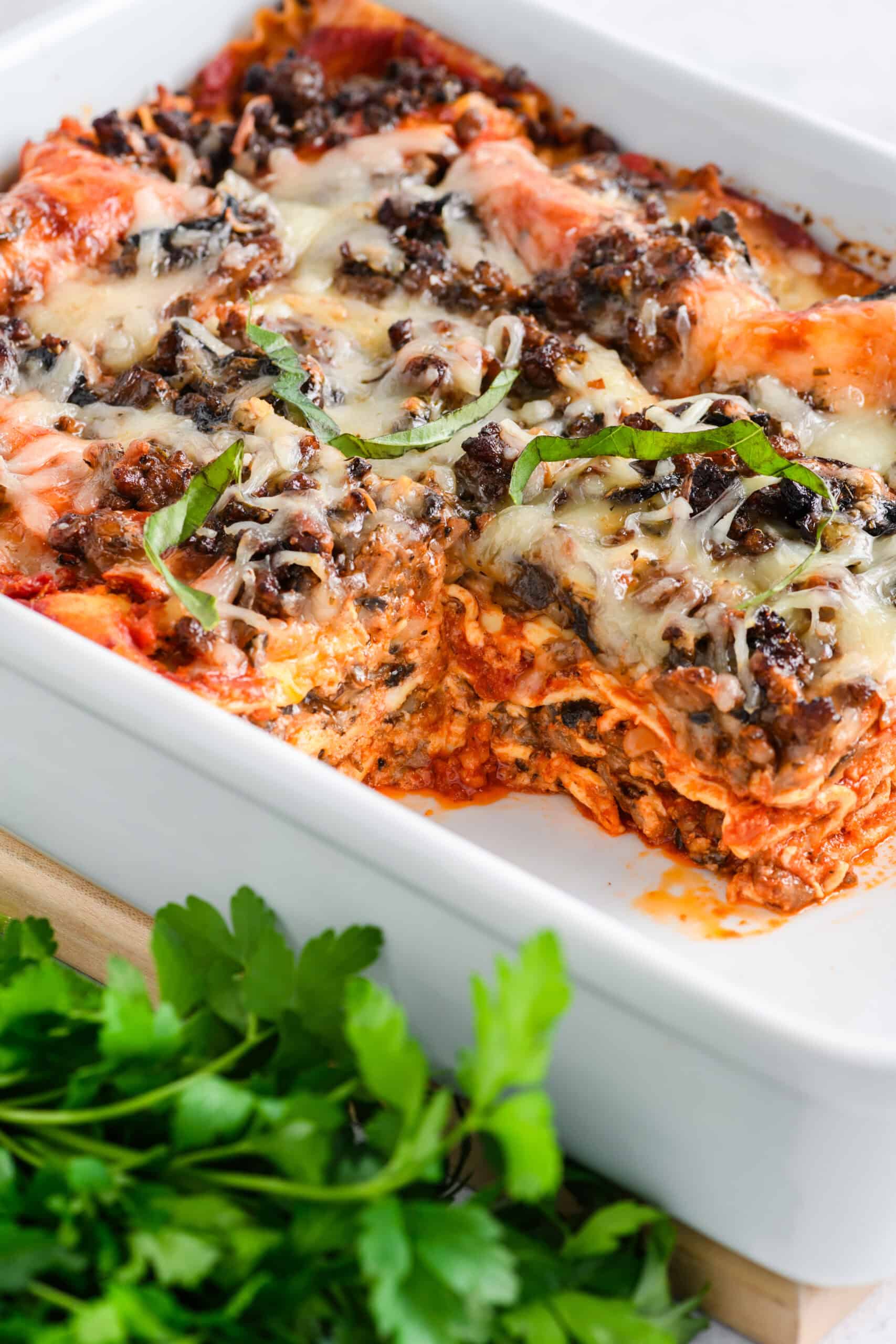 Close up shot of sliced Easy Sausage and Mushroom Lasagna in casserole dish.