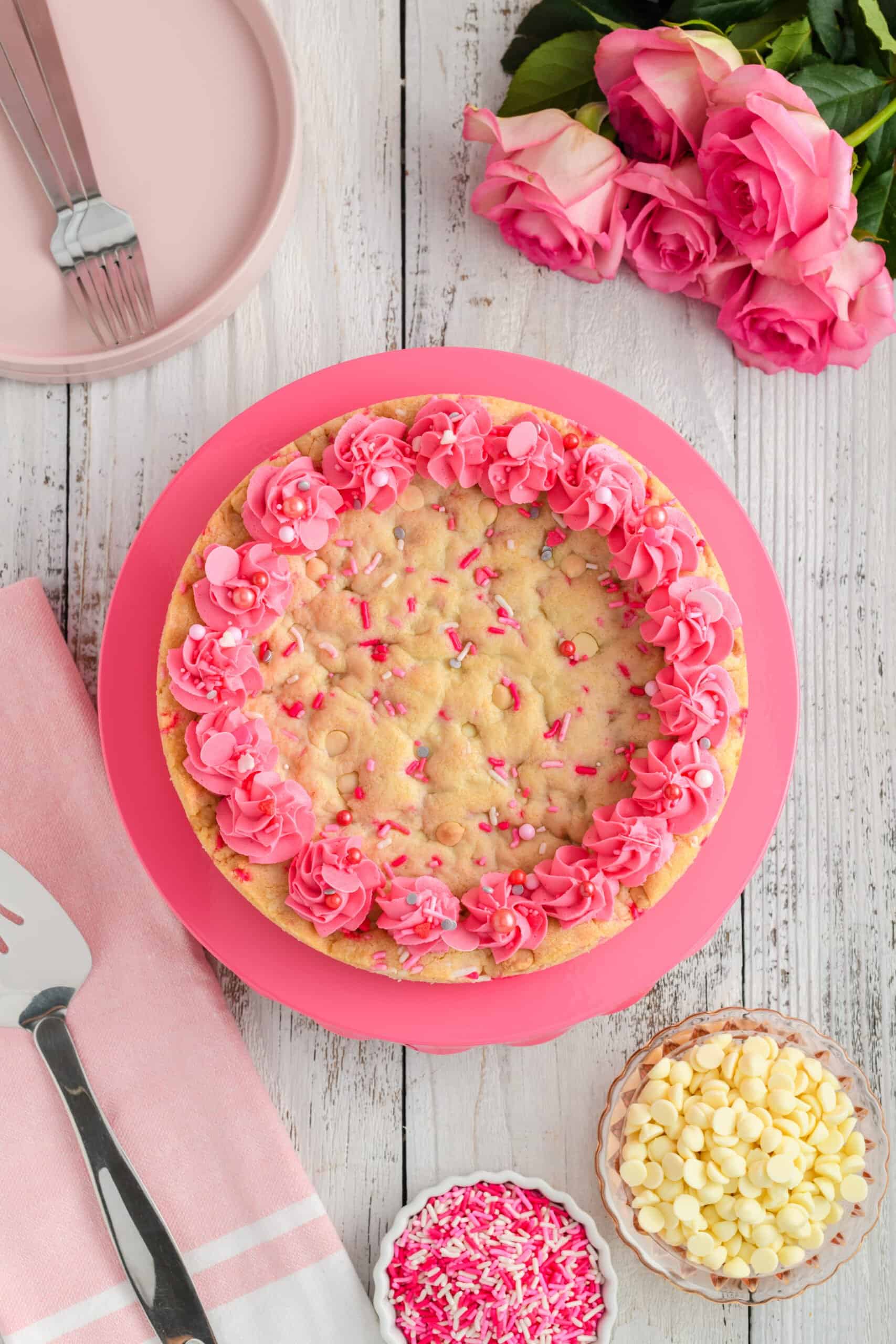 Overhead shot of Valentine Confetti Cookie Cake on pink pedestal.