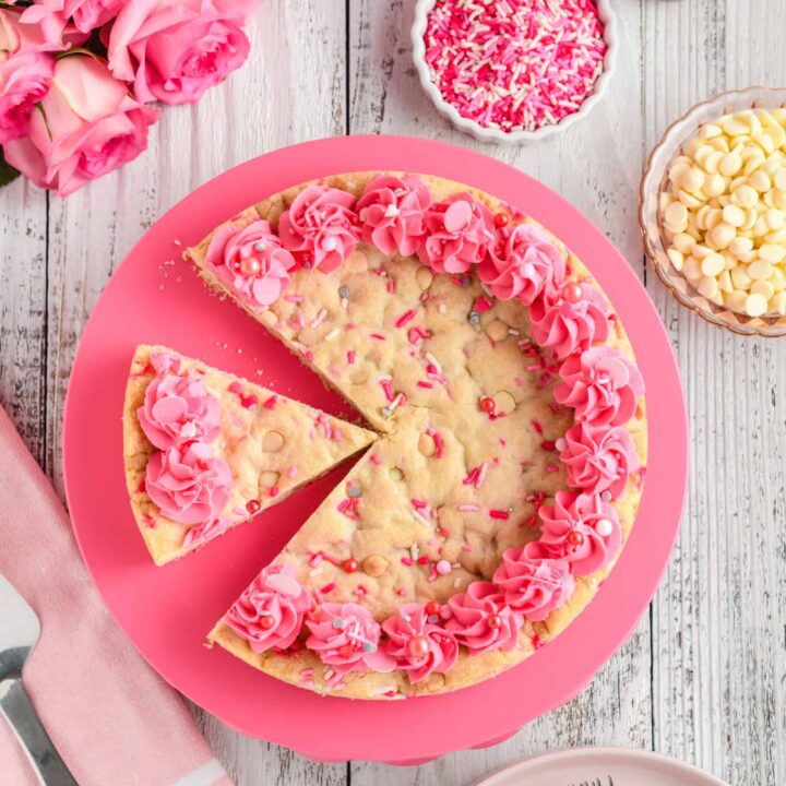 Overhead shot of Valentine Confetti Cookie Cake with slice missing.