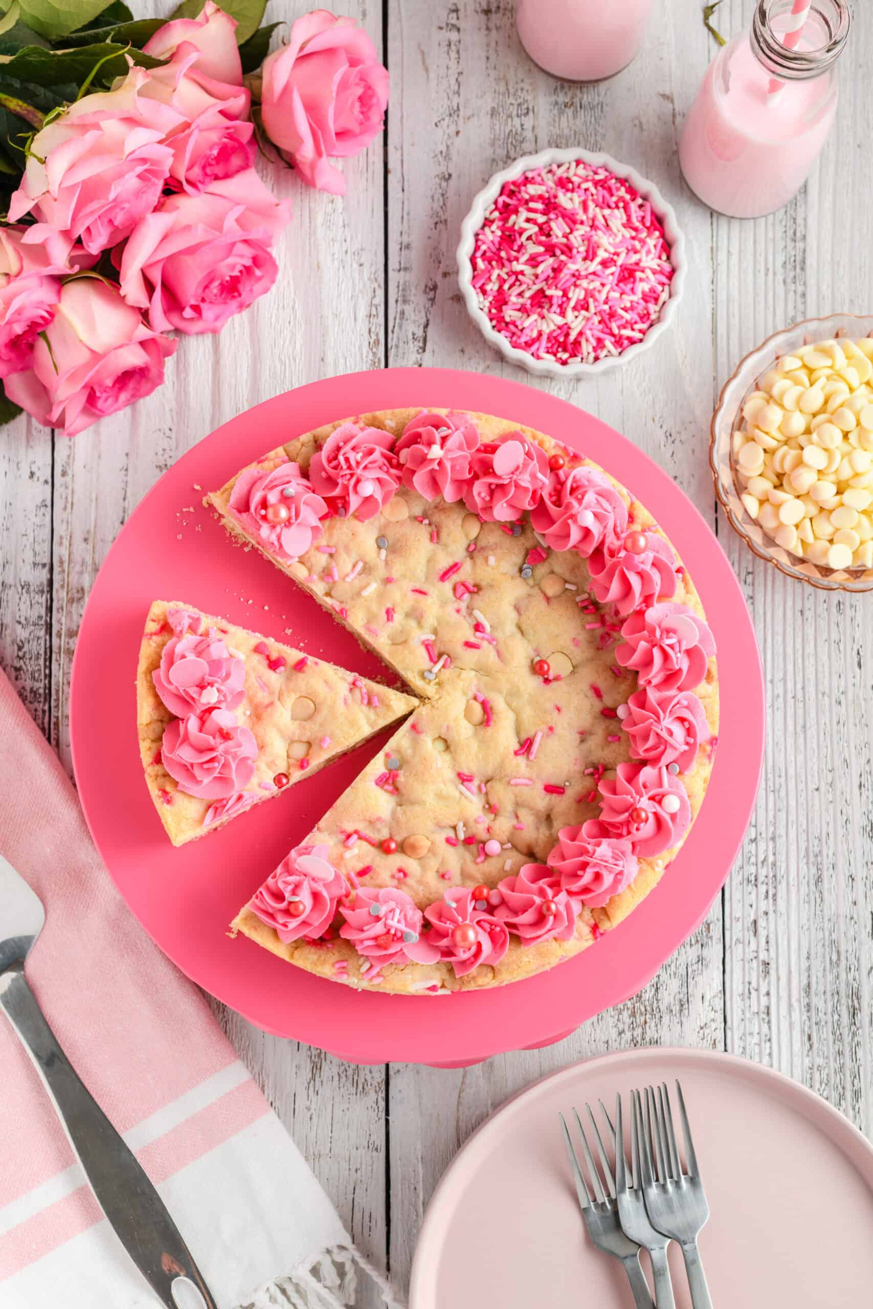 Overhead shot of Valentine Confetti Cookie Cake with slice missing.