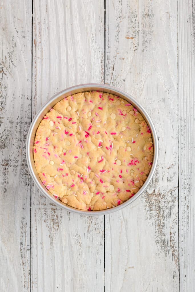 Overhead shot of baked Valentine Confetti Cookie Cake on pan.
